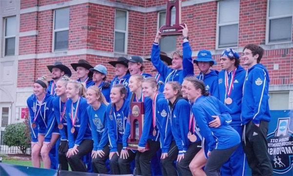 The men's and women's cross country teams pose with their trophies after winning NCAA Regional Championships. 